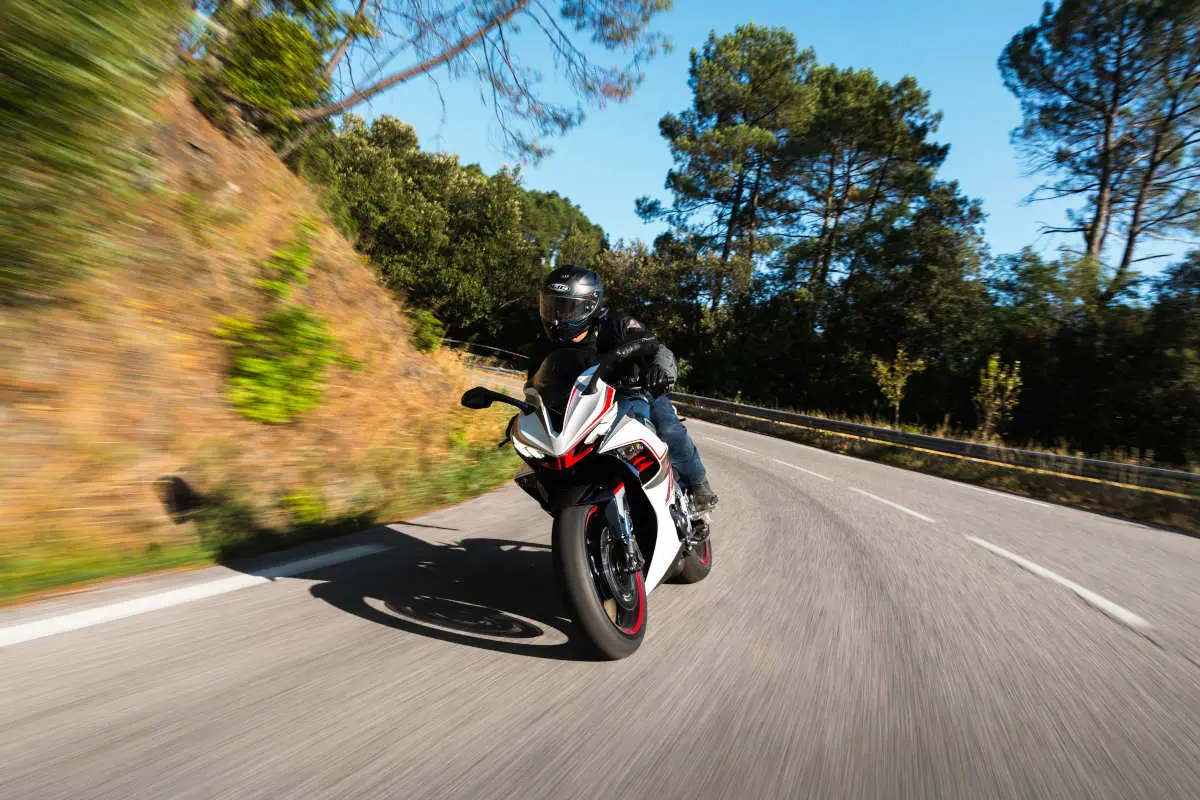 The bike in red on a wide bend