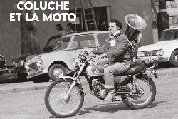 Une photo en noir et blanc avec Coluche sur une moto Yamaha AT2, un tuba de musique et de vieilles voitures.