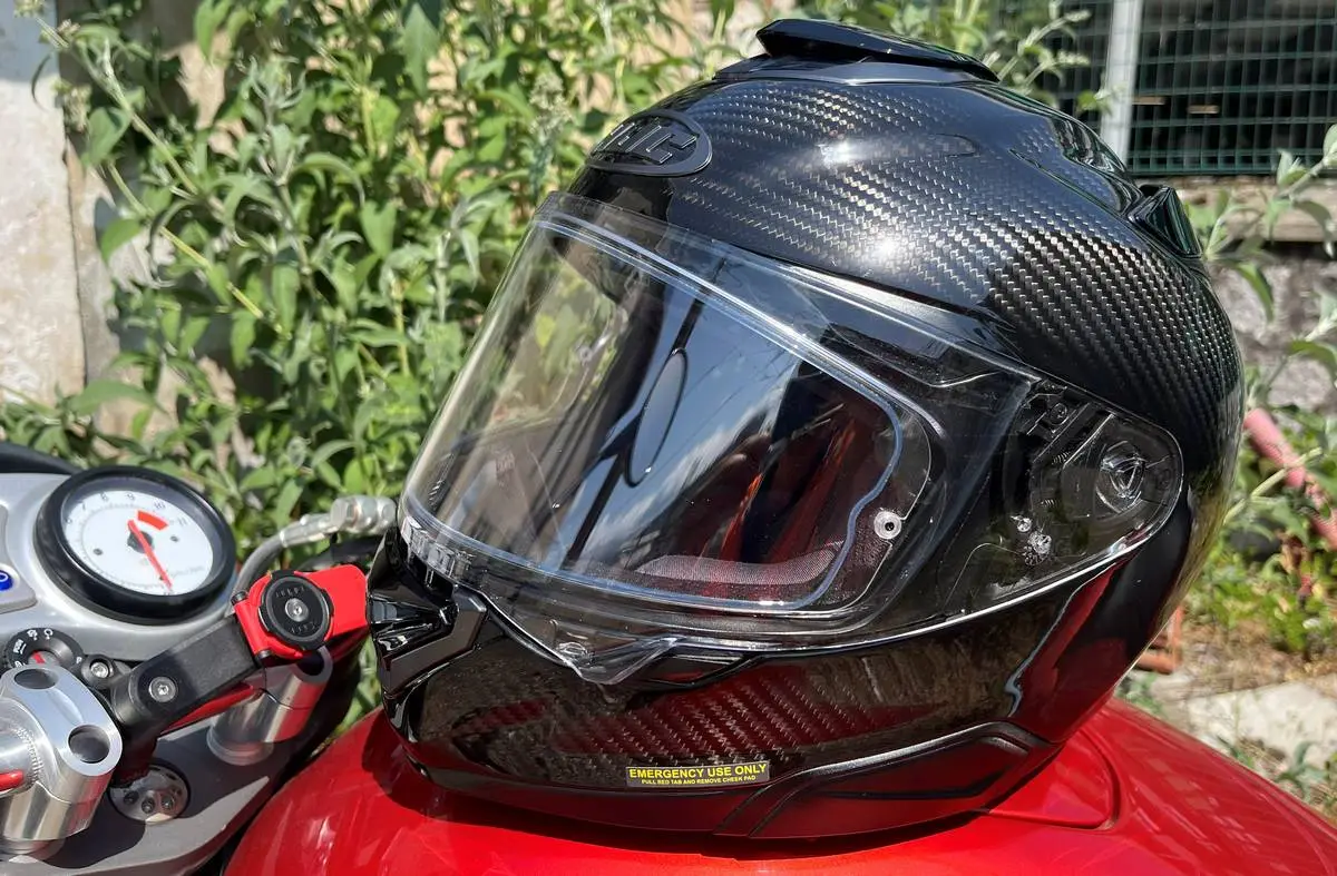 An HJC Rpha 72 helmet and some tree leaves